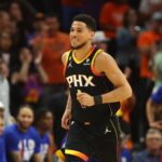 Phoenix Suns guards Devin Booker (1) smiles after a shot against the Los Angeles Clippers during the first half in game five of the 2023 NBA playoffs at Footprint Center.