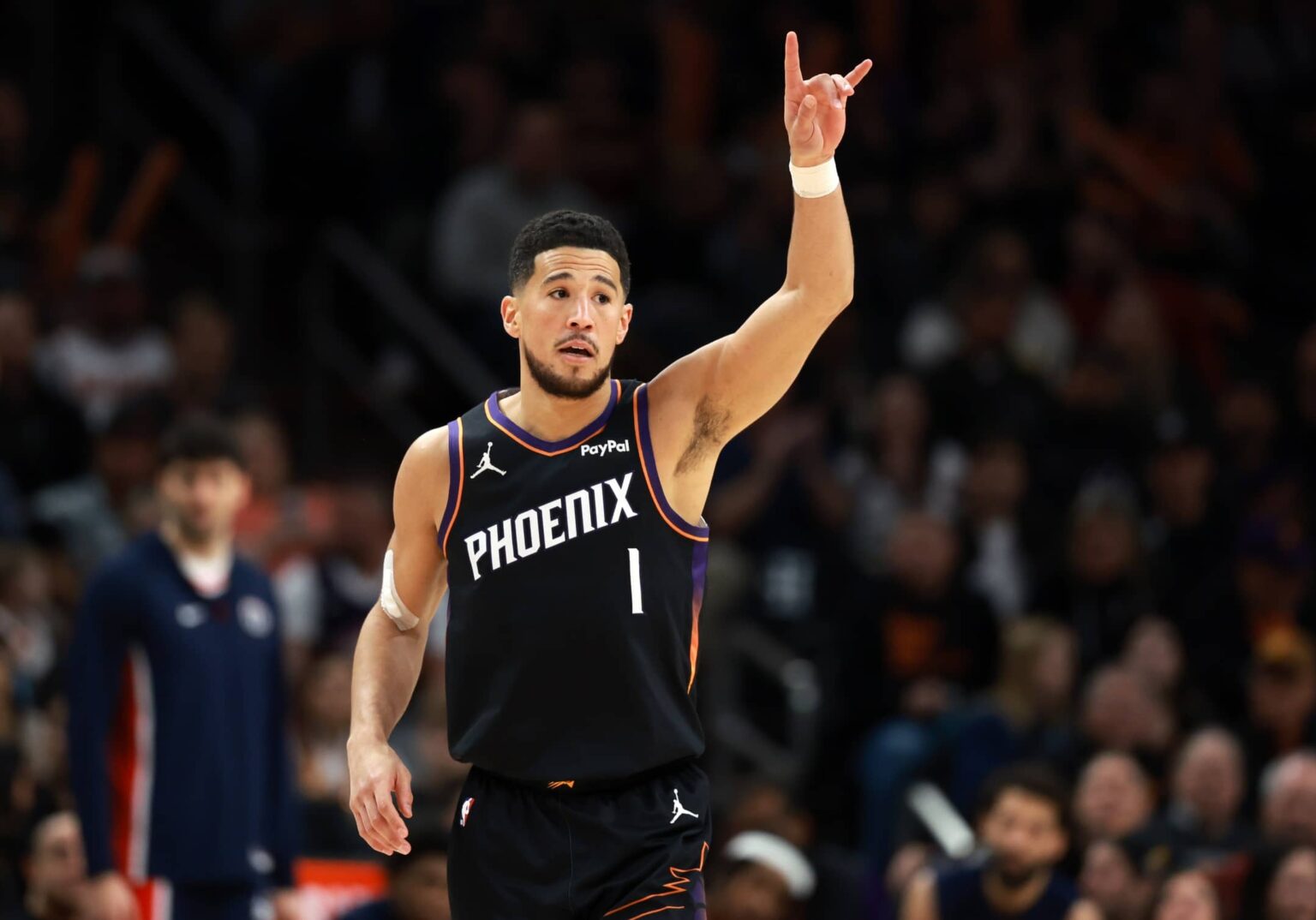 Jan 11, 2026; Phoenix, Arizona, USA; Phoenix Suns guard Devin Booker (1) reacts against the Washington Wizards in the first half at Mortgage Matchup Center. Mandatory Credit: Mark J. Rebilas-Imagn Images