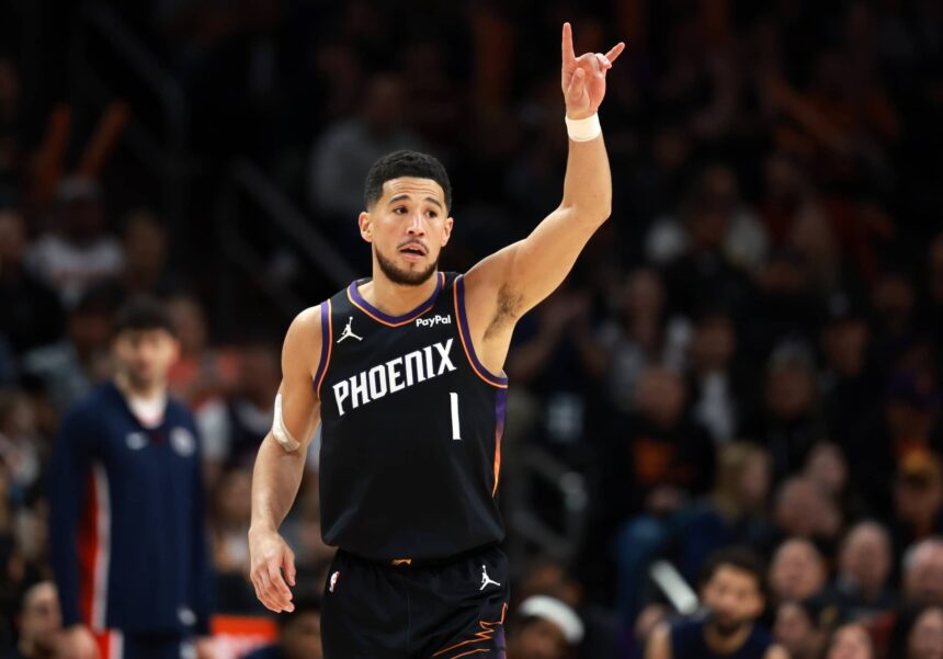 Jan 11, 2026; Phoenix, Arizona, USA; Phoenix Suns guard Devin Booker (1) reacts against the Washington Wizards in the first half at Mortgage Matchup Center. Mandatory Credit: Mark J. Rebilas-Imagn Images