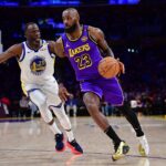 Los Angeles Lakers forward LeBron James (23) moves the ball against Golden State Warriors forward Draymond Green (23) during the first half at Crypto.com Arena.