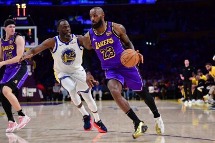 Los Angeles Lakers forward LeBron James (23) moves the ball against Golden State Warriors forward Draymond Green (23) during the first half at Crypto.com Arena.