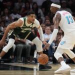 Apr 5, 2025; Miami, Florida, USA; Miami Heat center Bam Adebayo (13) looks to pass the ball as Milwaukee Bucks forward Giannis Antetokounmpo (34) defends during the second half at Kaseya Center. Mandatory Credit: Jim Rassol-Imagn Images