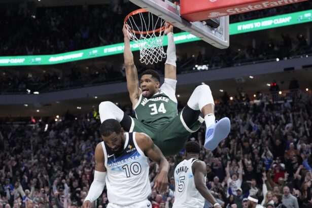 Apr 8, 2025; Milwaukee, Wisconsin, USA; Milwaukee Bucks forward Giannis Antetokounmpo (34) dunks the ball against Minnesota Timberwolves guard Mike Conley (10) in the second half at Fiserv Forum. Mandatory Credit: Michael McLoone-Imagn Images