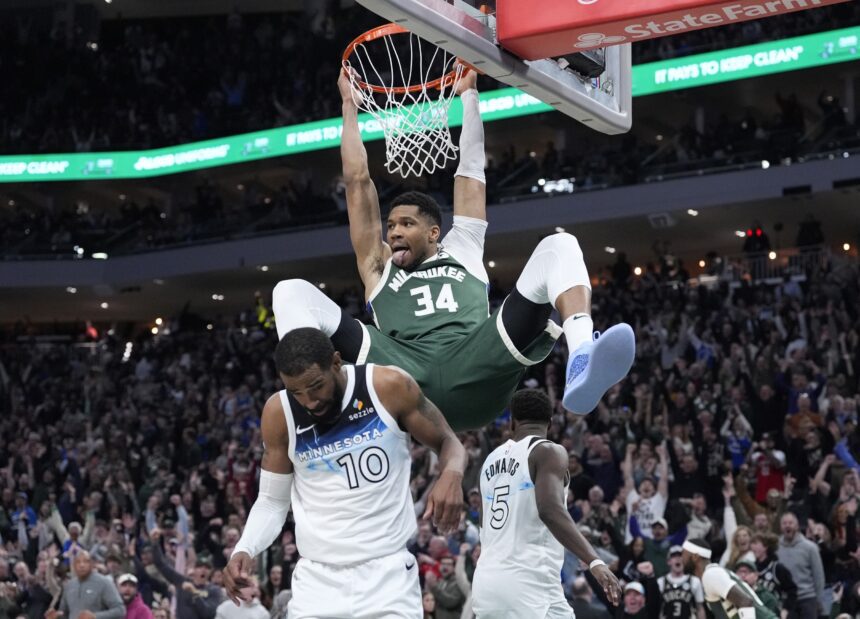 Apr 8, 2025; Milwaukee, Wisconsin, USA; Milwaukee Bucks forward Giannis Antetokounmpo (34) dunks the ball against Minnesota Timberwolves guard Mike Conley (10) in the second half at Fiserv Forum. Mandatory Credit: Michael McLoone-Imagn Images