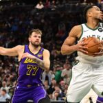 Mar 13, 2025; Milwaukee, Wisconsin, USA; Milwaukee Bucks forward Giannis Antetokounmpo (34) controls the ball against Los Angeles Lakers guard Luka Doncic (77) in the first quarter at Fiserv Forum. Mandatory Credit: Benny Sieu-Imagn Images