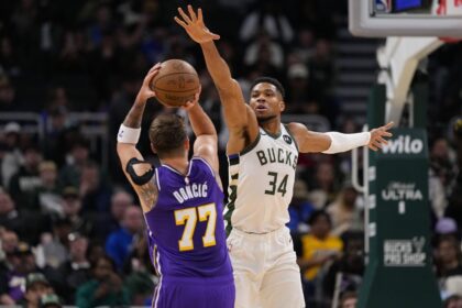 Nov 15, 2025; Milwaukee, Wisconsin, USA; Milwaukee Bucks forward Giannis Antetokounmpo (34) defends Los Angeles Lakers guard Luka Doncic (77) during the first quarter at Fiserv Forum. Mandatory Credit: Jeff Hanisch-Imagn Images