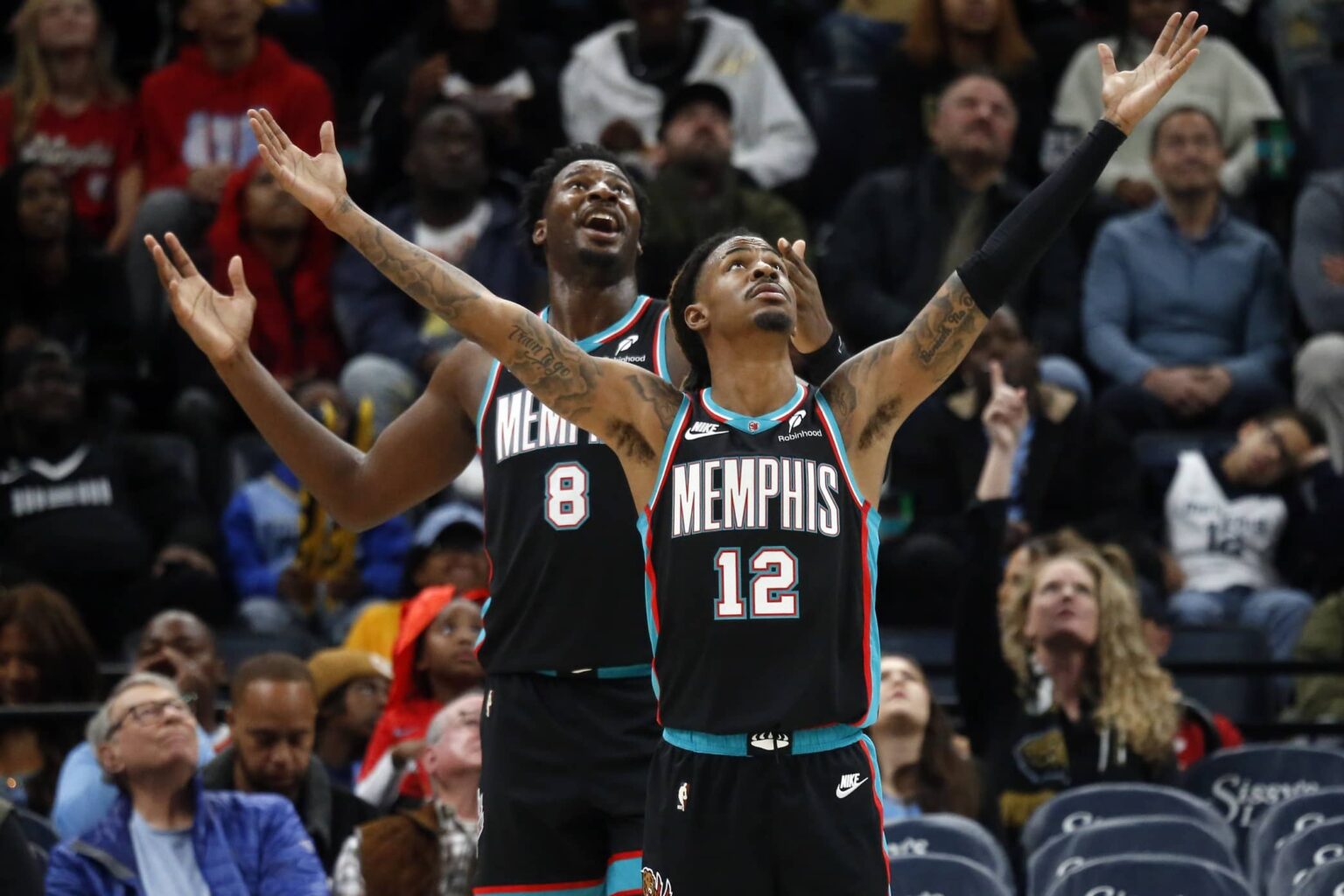 Nov 9, 2025; Memphis, Tennessee, USA; Memphis Grizzlies forward/center Jaren Jackson Jr. (8) and guard Ja Morant (12) react during the third quarter against the Oklahoma City Thunder at FedExForum. Mandatory Credit: Petre Thomas-Imagn Images