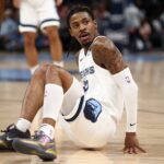 Dec 5, 2024; Memphis, Tennessee, USA; Memphis Grizzlies guard Ja Morant (12) reacts after falling during the first quarter against the Sacramento Kings at FedExForum. Mandatory Credit: Petre Thomas-Imagn Images