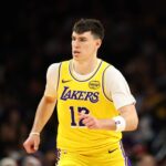 Dec 23, 2025; Phoenix, Arizona, USA; Los Angeles Lakers forward Jake LaRavia (12) against the Phoenix Suns at Mortgage Matchup Center. Mandatory Credit: Mark J. Rebilas-Imagn Images