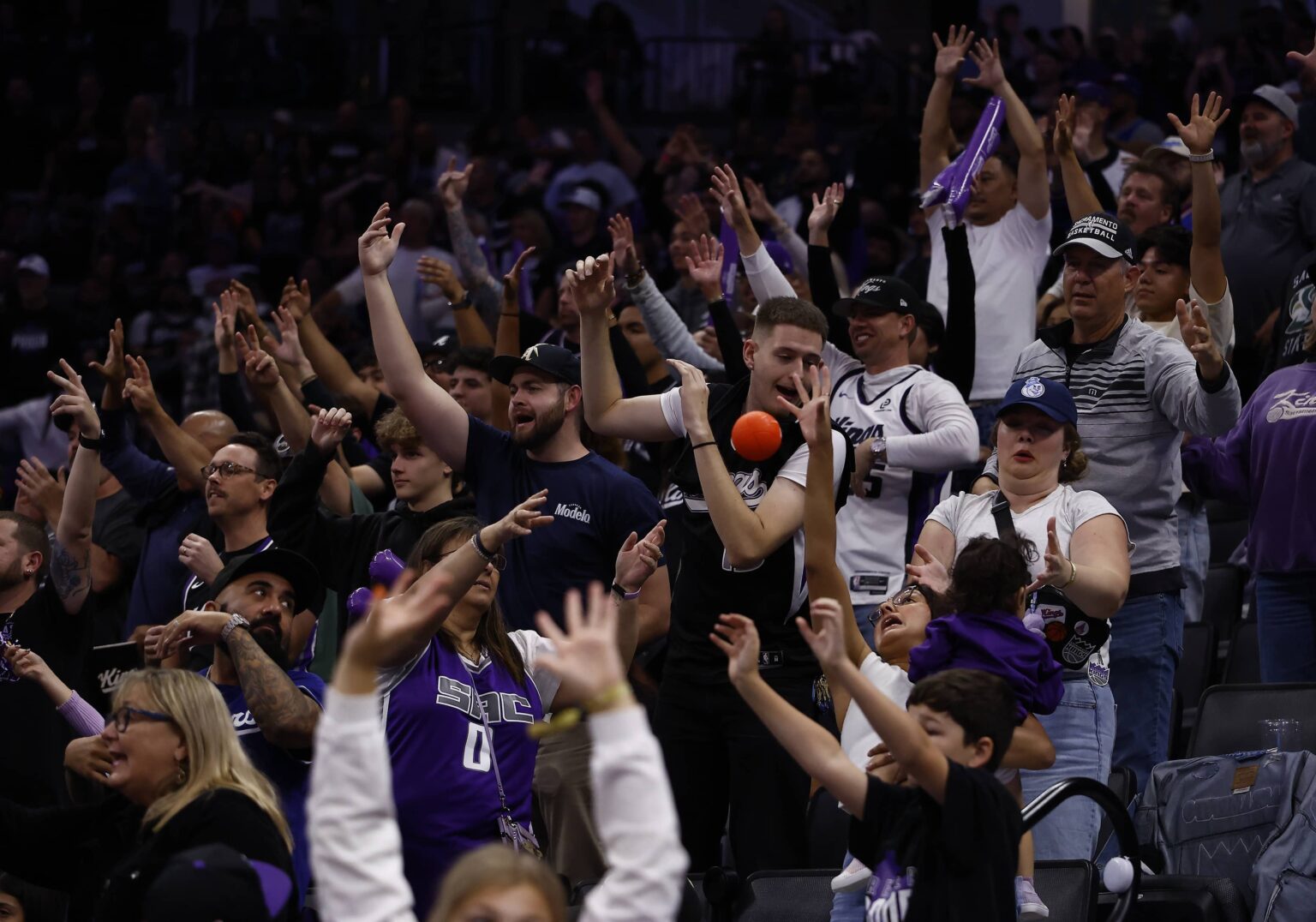 Sacramento Kings fans reach for a ball during a timeout against the Utah Jazz during the fourth quarter at Golden 1 Center.