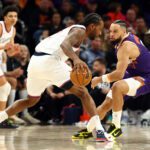 Feb 1, 2026; Phoenix, Arizona, USA; Los Angeles Clippers forward Kawhi Leonard (2) controls the ball against Phoenix Suns forward Dillon Brooks (3) in the second half at Mortgage Matchup Center. Mandatory Credit: Mark J. Rebilas-Imagn Images