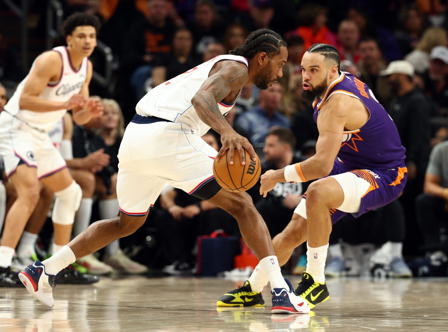 Feb 1, 2026; Phoenix, Arizona, USA; Los Angeles Clippers forward Kawhi Leonard (2) controls the ball against Phoenix Suns forward Dillon Brooks (3) in the second half at Mortgage Matchup Center. Mandatory Credit: Mark J. Rebilas-Imagn Images