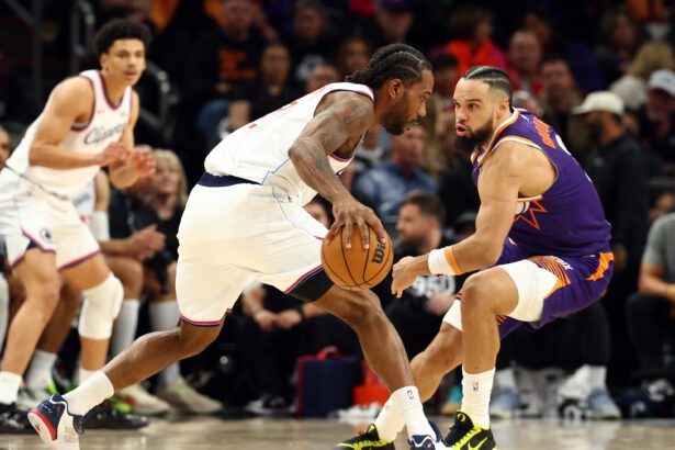 Feb 1, 2026; Phoenix, Arizona, USA; Los Angeles Clippers forward Kawhi Leonard (2) controls the ball against Phoenix Suns forward Dillon Brooks (3) in the second half at Mortgage Matchup Center. Mandatory Credit: Mark J. Rebilas-Imagn Images