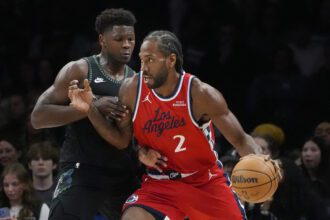 Feb 8, 2026; Minneapolis, Minnesota, USA; Los Angeles Clippers forward Kawhi Leonard (2) works around Minnesota Timberwolves guard Anthony Edwards (5) in the first quarter at Target Center. Mandatory Credit: Bruce Kluckhohn-Imagn Images