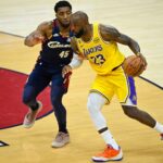 Jan 28, 2026; Cleveland, Ohio, USA; Cleveland Cavaliers guard Donovan Mitchell (45) defends Los Angeles Lakers forward LeBron James (23) in the fourth quarter at Rocket Arena. Mandatory Credit: David Richard-Imagn Images