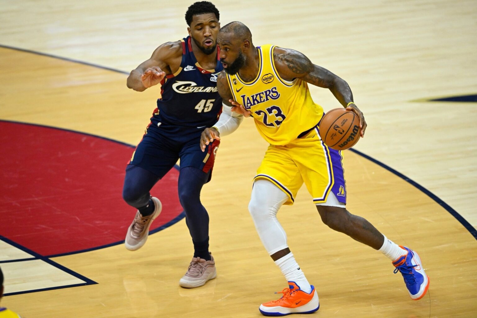 Jan 28, 2026; Cleveland, Ohio, USA; Cleveland Cavaliers guard Donovan Mitchell (45) defends Los Angeles Lakers forward LeBron James (23) in the fourth quarter at Rocket Arena. Mandatory Credit: David Richard-Imagn Images