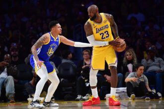 Feb 7, 2026; Los Angeles, California, USA; Los Angeles Lakers forward LeBron James (23) controls the ball against Golden State Warriors guard Will Richard (3) during the second half at Crypto.com Arena. Mandatory Credit: Gary A. Vasquez-Imagn Images