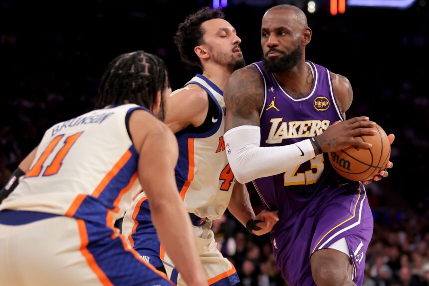 Feb 1, 2026; New York, New York, USA; Los Angeles Lakers forward LeBron James (23) drives to the basket against New York Knicks guards Jalen Brunson (11) and Landry Shamet (44) during the third quarter at Madison Square Garden. Mandatory Credit: Brad Penner-Imagn Images