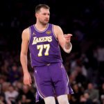Feb 1, 2026; New York, New York, USA; Los Angeles Lakers guard Luka Doncic (77) points in the direction of Knicks fan Spike Lee (not pictured) after a three point shot against the New York Knicks during the third quarter at Madison Square Garden. Mandatory Credit: Brad Penner-Imagn Images