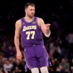 Feb 1, 2026; New York, New York, USA; Los Angeles Lakers guard Luka Doncic (77) points in the direction of Knicks fan Spike Lee (not pictured) after a three point shot against the New York Knicks during the third quarter at Madison Square Garden. Mandatory Credit: Brad Penner-Imagn Images