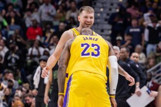 Jan 6, 2026; New Orleans, Louisiana, USA; Los Angeles Lakers forward LeBron James (23) jokes with forward/guard Luka Doncic (77) after a shot against the New Orleans Pelicans during the second half at Smoothie King Center. Mandatory Credit: Stephen Lew-Imagn Images