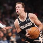 Jan 17, 2026; Atlanta, Georgia, USA; Atlanta Hawks guard Luke Kennard (4) shoots against the Boston Celtics in the first quarter at State Farm Arena. Mandatory Credit: Brett Davis-Imagn Images