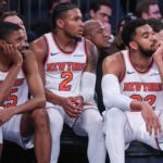 New York Knicks guards Mikal Bridges (25), Miles McBride (2), and center Karl-Anthony Towns (32) watch from the bench in the fourth quarter against the Orlando Magic at Madison Square Garden.