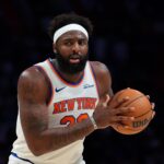 Nov 17, 2025; Miami, Florida, USA; New York Knicks center Mitchell Robinson (23) protects the basketball against the Miami Heat during the third quarter at Kaseya Center. Mandatory Credit: Sam Navarro-Imagn Images