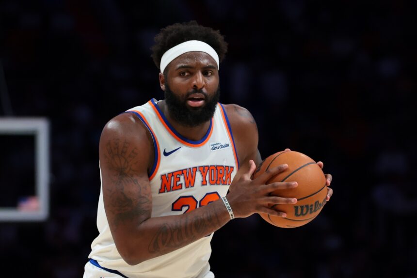 Nov 17, 2025; Miami, Florida, USA; New York Knicks center Mitchell Robinson (23) protects the basketball against the Miami Heat during the third quarter at Kaseya Center. Mandatory Credit: Sam Navarro-Imagn Images
