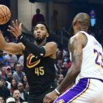 Nov 25, 2023; Cleveland, Ohio, USA; Cleveland Cavaliers guard Donovan Mitchell (45) drives to the basket against Los Angeles Lakers forward LeBron James (23) during the first half at Rocket Mortgage FieldHouse. Mandatory Credit: Ken Blaze-Imagn Images