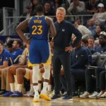 Oct 27, 2025; San Francisco, California, USA; Golden State Warriors head coach Steve Kerr meets with forward Draymond Green (23) after Green fouled out against the Memphis Grizzlies in the fourth quarter at the Chase Center. Mandatory Credit: Cary Edmondson-Imagn Images