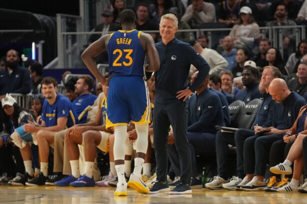 Oct 27, 2025; San Francisco, California, USA; Golden State Warriors head coach Steve Kerr meets with forward Draymond Green (23) after Green fouled out against the Memphis Grizzlies in the fourth quarter at the Chase Center. Mandatory Credit: Cary Edmondson-Imagn Images