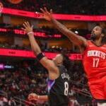 Feb 23, 2026; Houston, Texas, USA; Utah Jazz guard Isaiah Collier (8) shoots against Houston Rockets forward Tari Eason (17) in the second quarter at Toyota Center. Mandatory Credit: Thomas Shea-Imagn Images