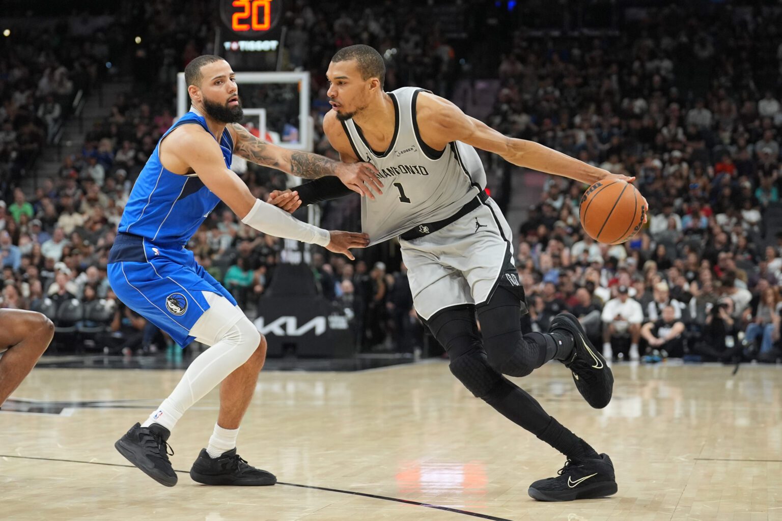 Feb 7, 2026; San Antonio, Texas, USA; San Antonio Spurs forward Victor Wembanyama (1) dribbles against Dallas Mavericks forward Caleb Martin (16) in the first half at Frost Bank Center. Mandatory Credit: Daniel Dunn-Imagn Images