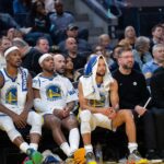 San Francisco, California, USA; Golden State Warriors guard Stephen Curry (30) on the bench with forward Jimmy Butler III (10) and guard Buddy Hield (7) and guard Gary Payton II (0) during the game against the LA Clippers during the fourth quarter at Chase Center. Mandatory Credit: Neville E. Guard-Imagn Images