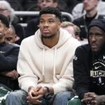 Mar 17, 2026; Milwaukee, Wisconsin, USA; Milwaukee Bucks guard Gary Harris (11), left, Milwaukee Bucks forward Giannis Antetokounmpo (34) and Milwaukee Bucks forward Taurean Prince (12) watch the game against the Cleveland Cavaliers from the bench in the second half at Fiserv Forum. Mandatory Credit: Michael McLoone-Imagn Images