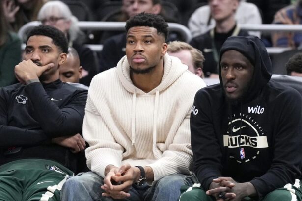 Mar 17, 2026; Milwaukee, Wisconsin, USA; Milwaukee Bucks guard Gary Harris (11), left, Milwaukee Bucks forward Giannis Antetokounmpo (34) and Milwaukee Bucks forward Taurean Prince (12) watch the game against the Cleveland Cavaliers from the bench in the second half at Fiserv Forum. Mandatory Credit: Michael McLoone-Imagn Images
