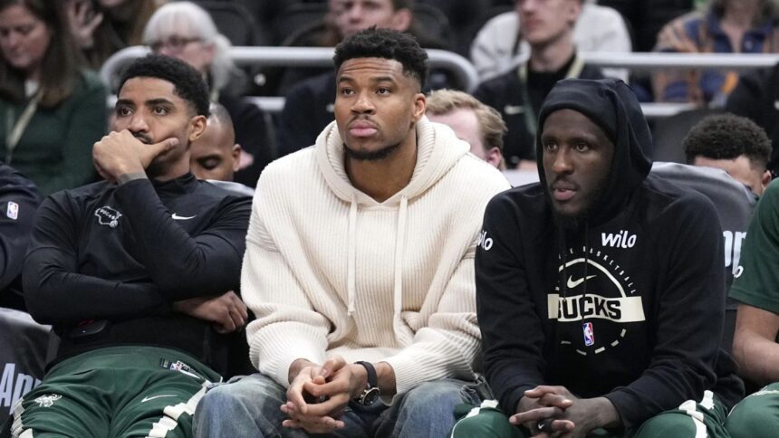 Mar 17, 2026; Milwaukee, Wisconsin, USA; Milwaukee Bucks guard Gary Harris (11), left, Milwaukee Bucks forward Giannis Antetokounmpo (34) and Milwaukee Bucks forward Taurean Prince (12) watch the game against the Cleveland Cavaliers from the bench in the second half at Fiserv Forum. Mandatory Credit: Michael McLoone-Imagn Images