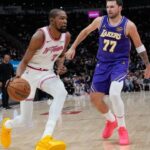 Houston Rockets’ Kevin Durant (7) drives toward the basket as Los Angeles Lakers’ Luka Doncic (77) defends during the first half of an NBA basketball game Wednesday, March 18, 2026, in Houston. (AP Photo/David J. Phillip)