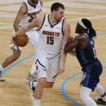 Feb 27, 2026; Oklahoma City, Oklahoma, USA; Denver Nuggets center Nikola Jokić (15) drives against Oklahoma City Thunder guard Luguentz Dort (5) during the second quarter at Paycom Center. Mandatory Credit: Alonzo Adams-Imagn Images | Alonzo Adams-Imagn Images