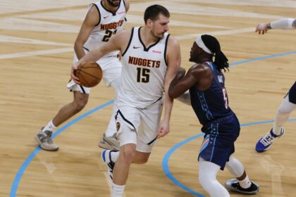 Feb 27, 2026; Oklahoma City, Oklahoma, USA; Denver Nuggets center Nikola Jokić (15) drives against Oklahoma City Thunder guard Luguentz Dort (5) during the second quarter at Paycom Center. Mandatory Credit: Alonzo Adams-Imagn Images | Alonzo Adams-Imagn Images