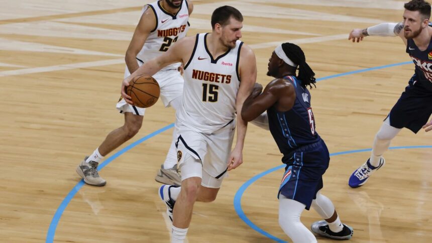 Feb 27, 2026; Oklahoma City, Oklahoma, USA; Denver Nuggets center Nikola Jokić (15) drives against Oklahoma City Thunder guard Luguentz Dort (5) during the second quarter at Paycom Center. Mandatory Credit: Alonzo Adams-Imagn Images | Alonzo Adams-Imagn Images