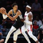MIAMI, FLORIDA – OCTOBER 15: Victor Wembanyama #1 of the San Antonio Spurs drives against Bam Adebayo #13 of the Miami Heat during the first quarter of a preseason game at Kaseya Center on October 15, 2024 in Miami, Florida. | Credit: Megan Briggs/Getty Images