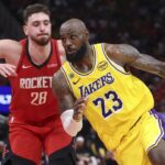 Apr 24, 2026; Houston, Texas, USA; Los Angeles Lakers forward LeBron James (23) drives with the ball as Houston Rockets center Alperen Sengun (28) defends during the fourth quarter during game three of the first round of the 2026 NBA Playoffs at Toyota Center. Mandatory Credit: Troy Taormina-Imagn Images