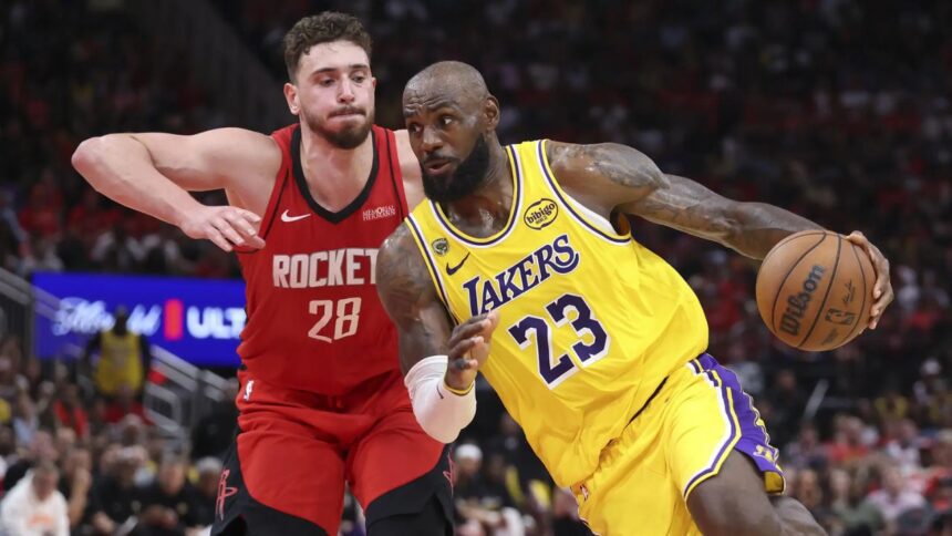 Apr 24, 2026; Houston, Texas, USA; Los Angeles Lakers forward LeBron James (23) drives with the ball as Houston Rockets center Alperen Sengun (28) defends during the fourth quarter during game three of the first round of the 2026 NBA Playoffs at Toyota Center. Mandatory Credit: Troy Taormina-Imagn Images