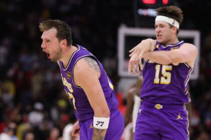 HOUSTON, TEXAS - MARCH 18: Austin Reaves #15 of the Los Angeles Lakers celebrates with Luka Doncic #77 of the Los Angeles Lakers during the second half against the Houston Rockets at Toyota Center on March 18, 2026 in Houston, Texas. (Photo by Alex Slitz/Getty Images)