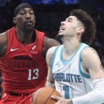 Nov 27, 2024; Charlotte, North Carolina, USA; Charlotte Hornets guard LaMelo Ball (1) drives past Miami Heat center/forward Bam Adebayo (13) during the second half at the Spectrum Center. Mandatory Credit: Sam Sharpe-Imagn Images