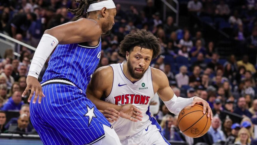 Mar 1, 2026; Orlando, Florida, USA; Detroit Pistons guard Cade Cunningham (2) drives against Orlando Magic center Wendell Carter Jr. (34) during the first quarter at Kia Center. Mandatory Credit: Mike Watters-Imagn Images
