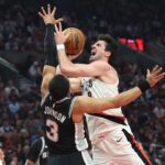 Portland Trail Blazers forward Deni Avdija shoots the ball over San Antonio Spurs forward Keldon Johnson during the first half during game three of the first round of the 2026 NBA Playoffs at Moda Center. Mandatory Credit: Jaime Valdez-Imagn Images