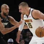 Denver Nuggets center Nikola Jokic (15) works around Minnesota Timberwolves center Rudy Gobert (27) in the first quarter at Target Center.